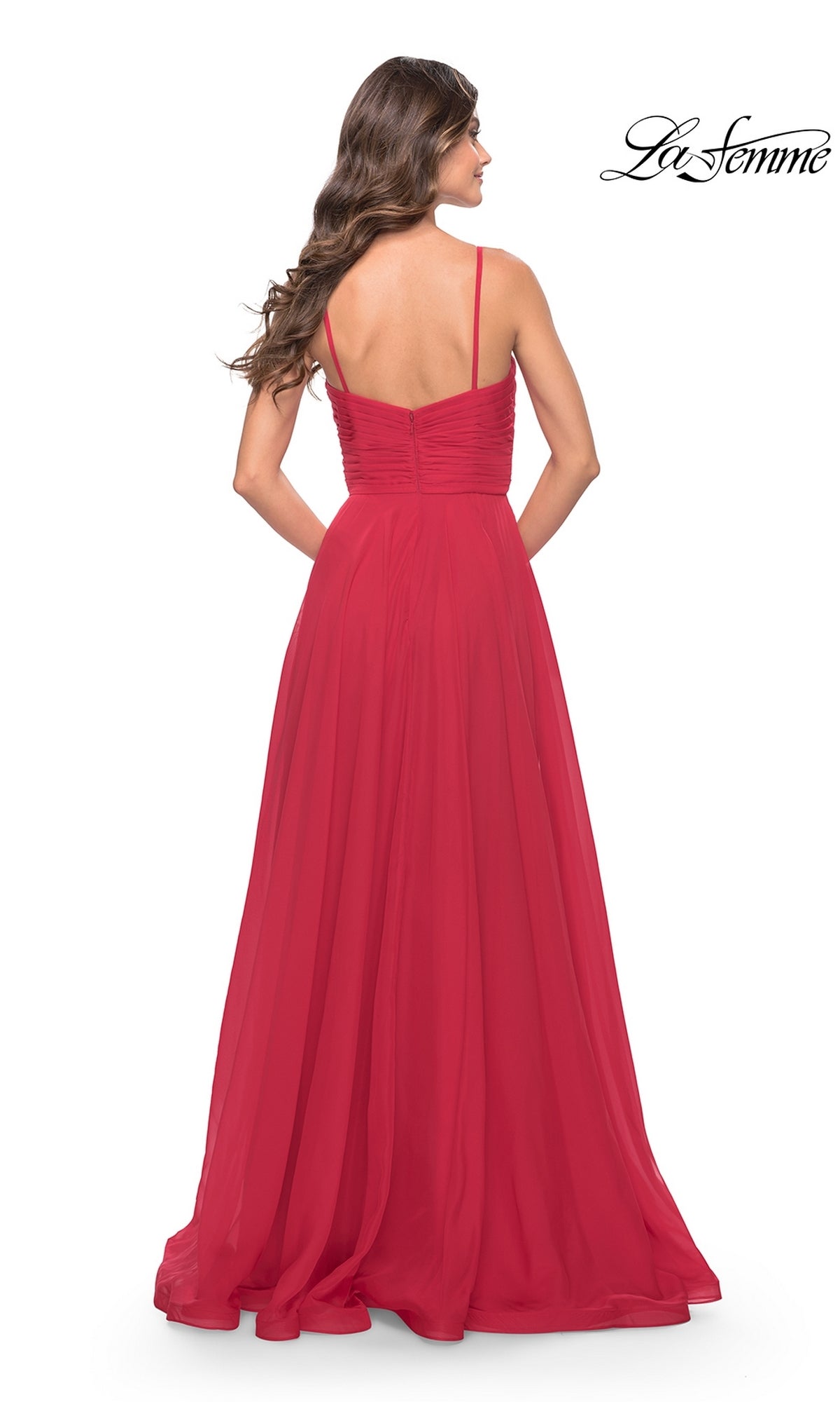 A woman with long brown hair wears the La Femme V-Neck Long A-Line Prom Dress 31500, a floor-length red gown with spaghetti straps, seen from the back against a white background. The La Femme logo is in the top right corner.